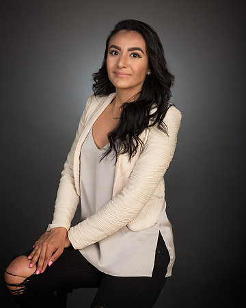 woman with white jacket against gray background for studio portrait photography headshot