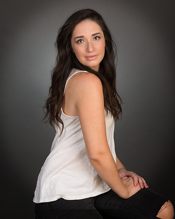 woman with white shirt against gray background for studio portrait photography headshot