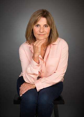 woman with pink shirt against gray background for studio portrait photography headshot