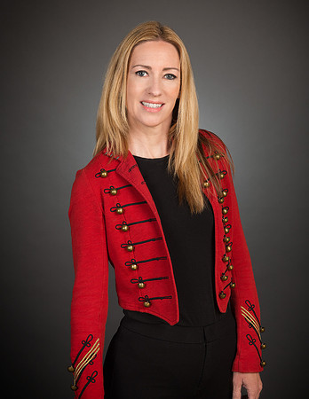 woman with red jacket against gray background for studio portrait photography headshot