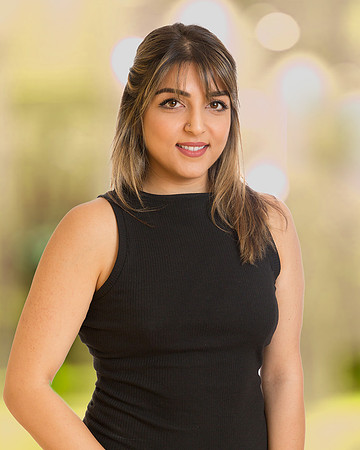 woman executive headshot portrait with office blurred yellow background