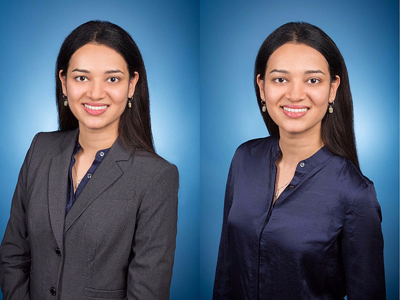 woman with black hair and gray jacket for headshot corporate with blue background