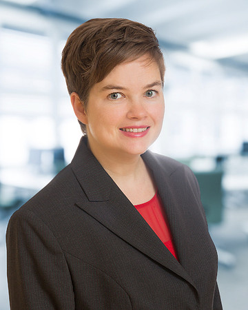 Woman with red shirt and jacket for Executive Corporate headshot with blurred office background
