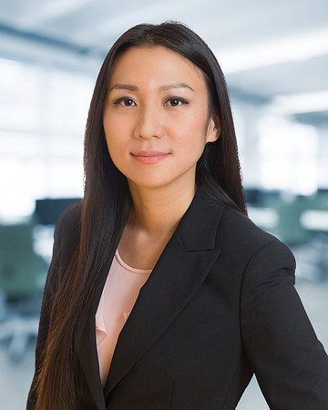 woman with pink shirt and jacket for Executive Corporate headshot with blurred office background