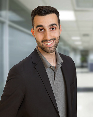 Man with barb and gray shirt for executive corporate headshot with blurred office background