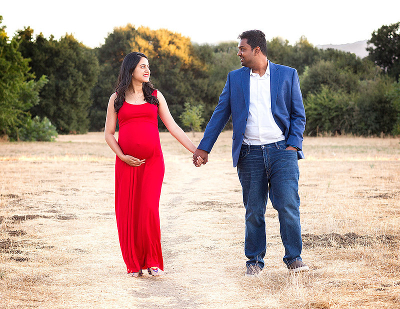 maternity session couple walking together holding their hands
