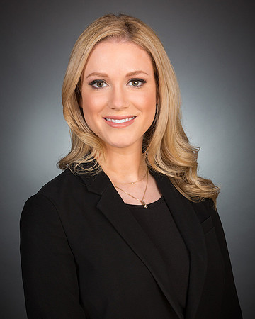 woman with blond hair against gray backdrop studio