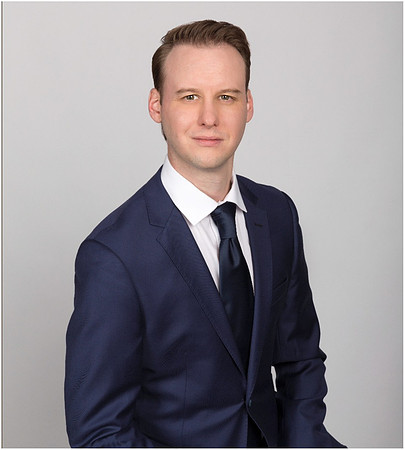 man_with_suit_portrait_studio_gray_background