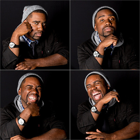 man_laughing_studio_portrait_with_black_background