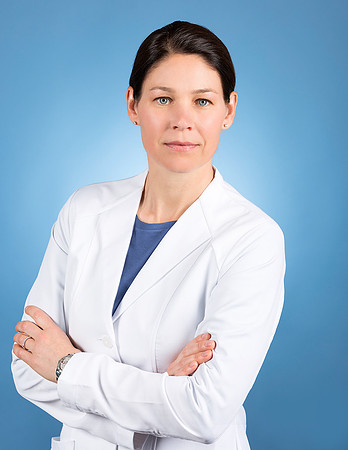 woman_in_medical_lab_coat_white_portrait