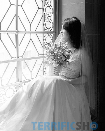 wedding_bride_posing_by_window_with_flower_san_francisco_city_hall_black_white