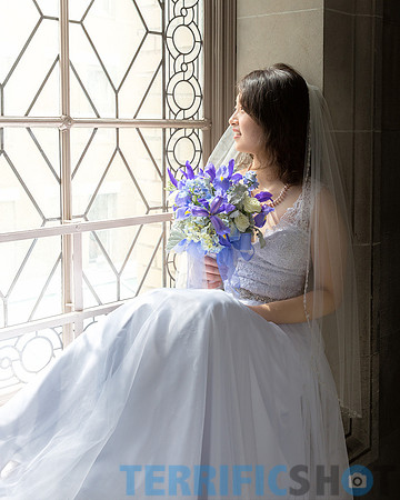 wedding_bride_posing_by_window_with_flower_san_francisco_city_hall
