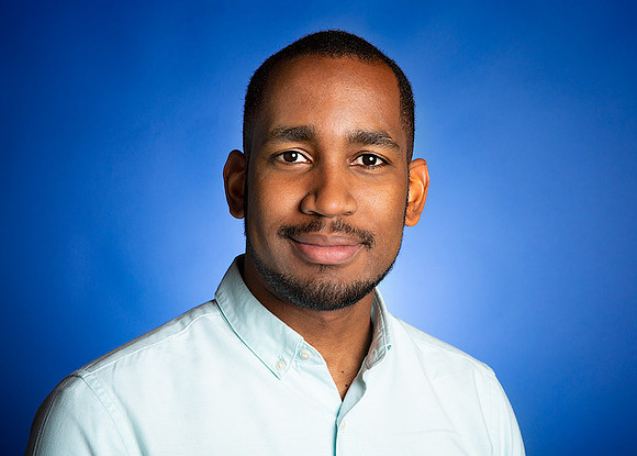 man_with_light_blue_shirt_studio_background