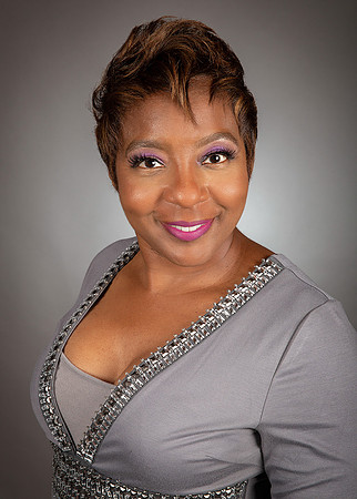 woman_wearing_gray_dress_short_hair_studio_portrait