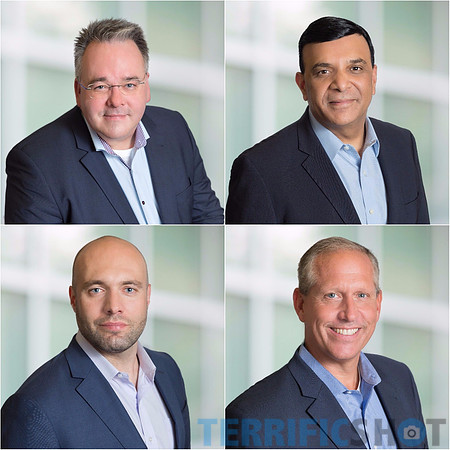 corporate_executive_men_headshot_with_blurred_office_background-min