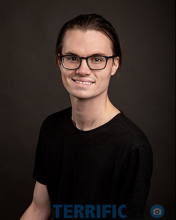 man_headshot_wearing_glasses_darker_background-min