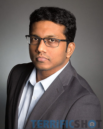 man_wearing_gray_jacket_portrait_headshot_studio-min