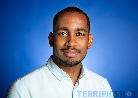man_with_light_blue_shirt_studio_background-min