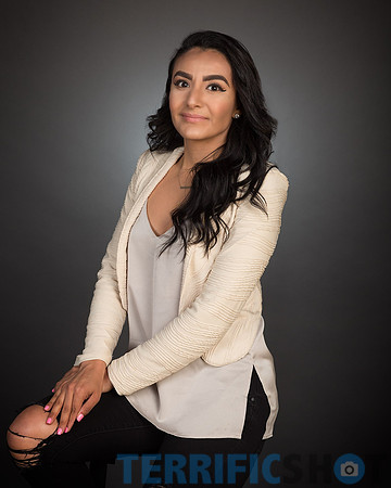 woman-black-hair-with-gray-background-studio-portrait-min