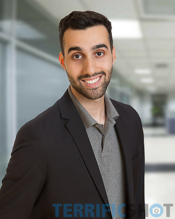 young_man_portrait_corporate_with_blurred_office_background-min
